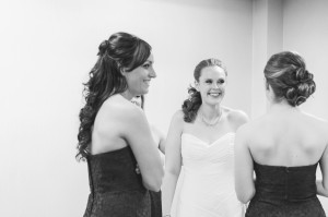 Bride getting dressed with bridesmaids
