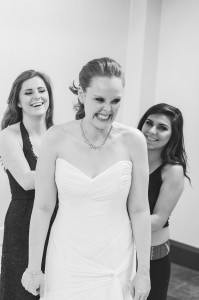 Bride getting dressed with bridesmaids
